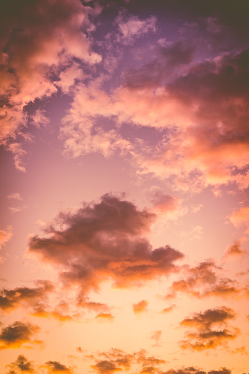 photo of cumulus clouds during golden hour services